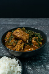 Spicy pork bone curry with betel leaves and rice, a local dish from southern Thailand.