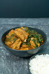 Spicy pork bone curry with betel leaves and rice, a local dish from southern Thailand.