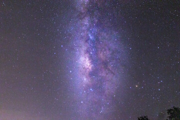 Galactic Glow for Creative Media : A mesmerizing view of the Milky Way glowing over a hillside at first light, offering a versatile image for creative projects. Its ethereal beauty suits book covers, 