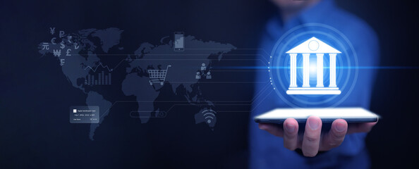 Online digital banking and financial technology concept: A man uses his tablet to access mobile transactions worldwide