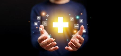 Healthcare and health insurance concept. A man holding health cross symbol with icons