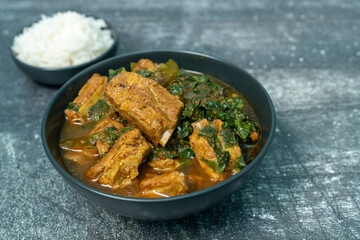 Spicy pork bone curry with betel leaves and rice, a local dish from southern Thailand.