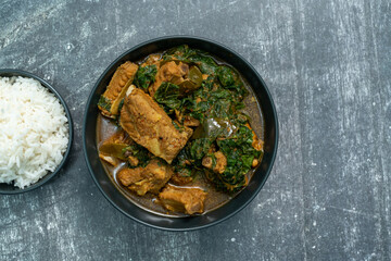 Spicy pork bone curry with betel leaves and rice, a local dish from southern Thailand.