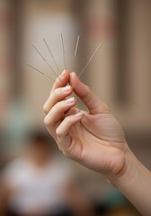 Hand Holding Acupuncture Needles: A Serene Medical Image