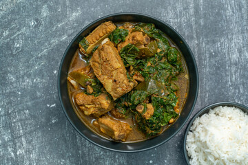 Spicy pork bone curry with betel leaves and rice, a local dish from southern Thailand.