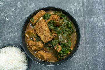 Spicy pork bone curry with betel leaves and rice, a local dish from southern Thailand.