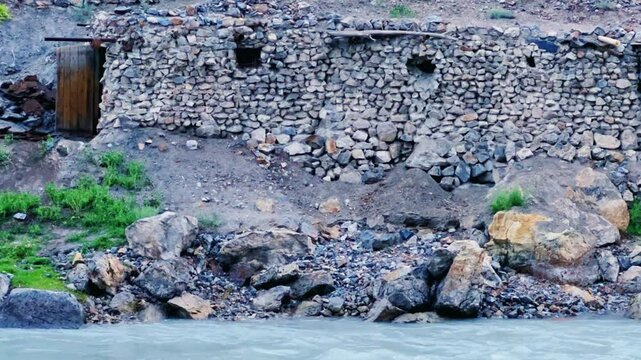 Old villages in Tajikistan. Tajikistan's road along the Zeravshan River near the Pamir highway. Old stone villages in the mountains of the Silk Road. 4К