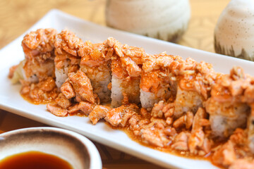 Close-up of sushi roll overloaded with savory salmon chunks. A fusion sushi dish combining...