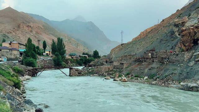 Old villages in Tajikistan. Tajikistan's road along the Zeravshan River near the Pamir highway. Old stone villages in the mountains of the Silk Road. 4К