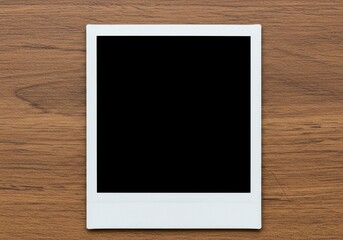 A blank instant photo frame is displayed on a textured wooden surface ready for customization