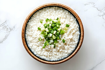 White rice dish topped with green onions in a bowl.