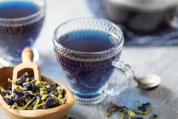 Blue tea Anchan or Butterfly pea in glass cup with dry flower of clitoria. Asian drink