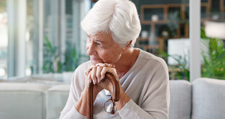 Senior woman, thinking and sad in nursing home with cane, depression and person with a disability...