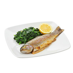 Grilled fish served on a white plate with saut&eacute;ed greens and lemon slice