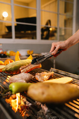A joyful group of friends gathers in a backyard at night, grilling meat and vegetables, enjoying food, laughter, and summer vibes.