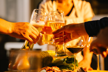 Friends and family enjoy a summer barbecue outdoors, grilling meat and vegetables, laughing, drinking, and celebrating together in the backyard.