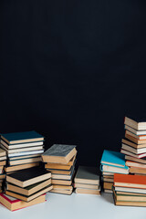 Stacks of educational books for learning on a black background