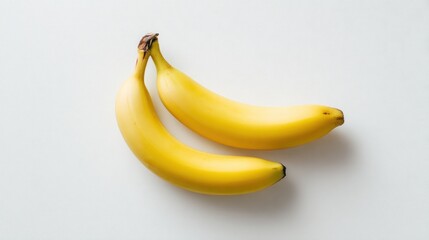 Two ripe bananas on a white surface
