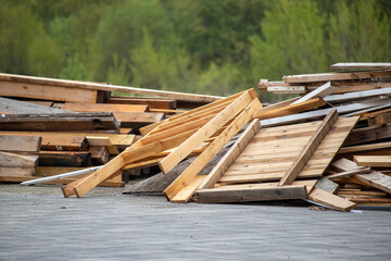 A pile of wood is scattered on the ground