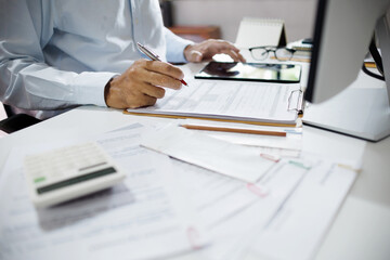 asian businessman checking document and business contract working with tablet and meeting online via desktop PC