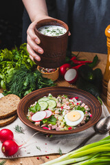 Okroshka on kefir with radishes and herbs