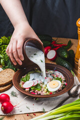Okroshka on kefir with radishes and herbs
