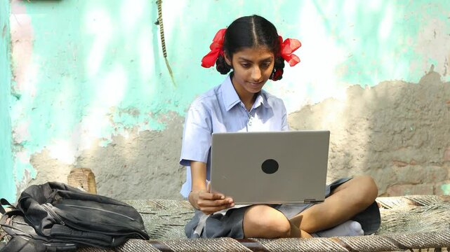 Portrait of Rural indian school girl using laptop, Female student working on computer. digital education india.4k - Powered by Adobe