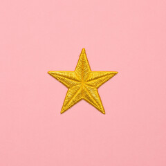 Fototapeta premium Golden Star Embroidery on Pink Fabric