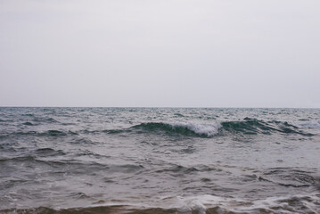Waves of the sea on a cloudy day. Selective focus.