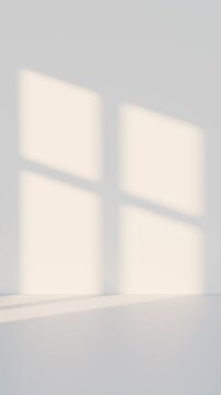 Soft sunlight casting window shadows on a light wall and floor, creating a calm and minimalistic interior atmosphere. Ideal for background, design mockups, or architectural concepts.
