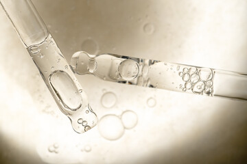 samples serum tests glass pipettes with drops of serum on a light beige background