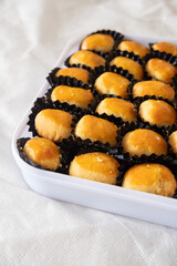 Kue Nastar and Putri Salju (Pineapple Tart and Snow-White Cookie) in a white box and background. Famous delicacy for Lebaran (Eid al-Fitr), Natal (Christmas), and Imlek (Chinese New Year) in Indonesia