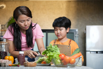 Mother and Son Preparing Salad in Kitchen, Asian Mother and Child Cooking Together at Home