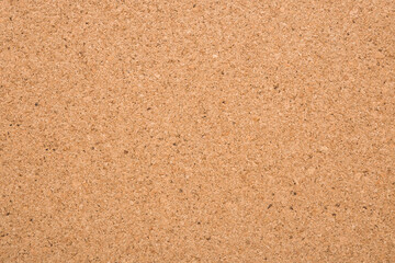 Light brown cork board background. Closeup. Empty place for text. Top down view.