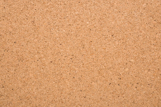 Light brown cork board background. Closeup. Empty place for text. Top down view.