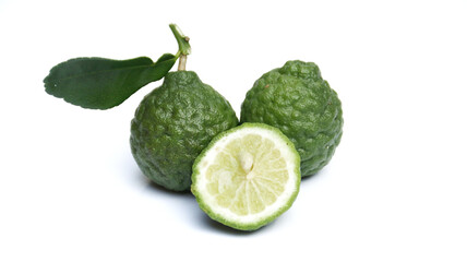 Fresh Bergamot orange, Citrus bergamia or kaffir lime (jeruk purut) fruits with green leaves and sliced, isolated on white background