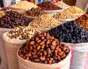 Rows of Moroccan dates and nuts displayed at a traditional desert market