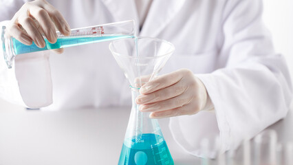 Fototapeta premium Hands Performing Scientific Experiments in a Modern Laboratory Setting.