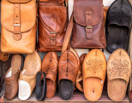 A collection of handcrafted Moroccan leather goods, such as bags and slippers, showcases the artisanal skills and craftsmanship.