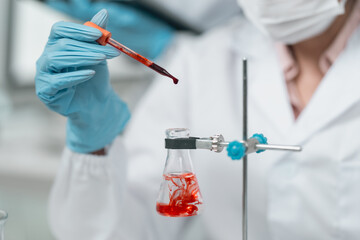 Medical research team conducting health and pharmaceutical experiments using blood samples in laboratory to develop advanced treatments and vaccines for global healthcare innovation