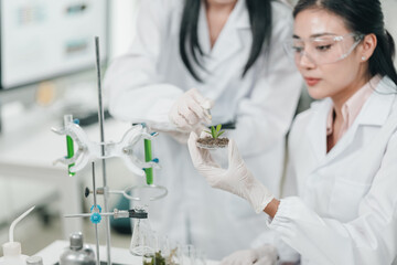 Medical science research team in modern laboratory conducting experiments, analyzing samples under...