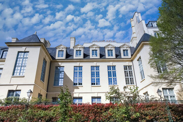 Paris, the square Saint-Gilles, public garden in the 3e arrondissement, with typical buildings in background 
