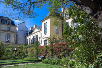 Paris, the square Saint-Gilles, public garden in the 3e arrondissement, with typical buildings in...