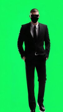 Stylish Businessman in a Suit and Mask Posing with Confidence on a Green Background
