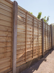 A set of newly installed set of treated overlap fence panels