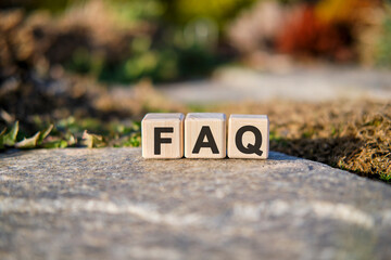 Fag text on cubes standing on a stone on a natural background