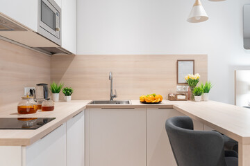 a small, bright kitchen with wooden countertops. built-in kitchen with lower and upper cabinets....