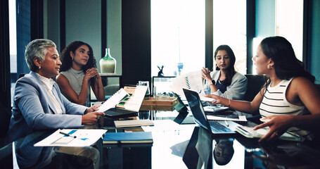 Business women, document and group discussion in meeting for planning with profit metrics. Team, chart and brainstorming with manager for investment idea, proposal and financial strategy in office