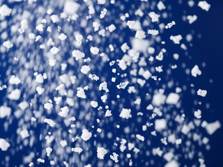 Abstract image of falling white salt crystals against a deep blue background