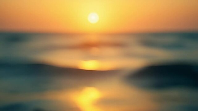 Blurred golden sea at sunset with shifting focus and bokeh effect. Sun reflects and sparkles on waves, illuminating golden sea. Holiday recreation concept. Abstract nautical summer ocean sunset nature